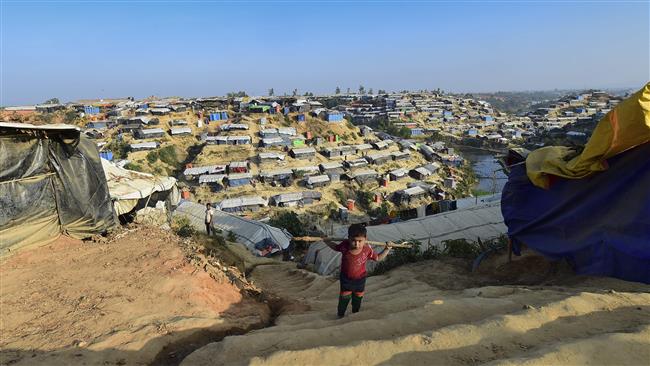 A Rohingya refugee child climbs stairs at Hakimpara refugee camp in Bangladesh