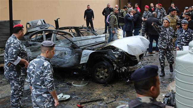 Lebanese security forces stand near a damaged vehicle following a car bomb blast in the southern Lebanese port city of Sidon on January 14, 2018. (Photo by AFP)