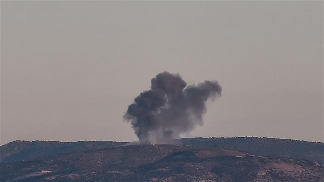 This photo taken on January 28, 2018, shows smoke rising on the Syrian side of the border from Hassa district in Hatay province, southern Turkey. (Photo by AFP)
