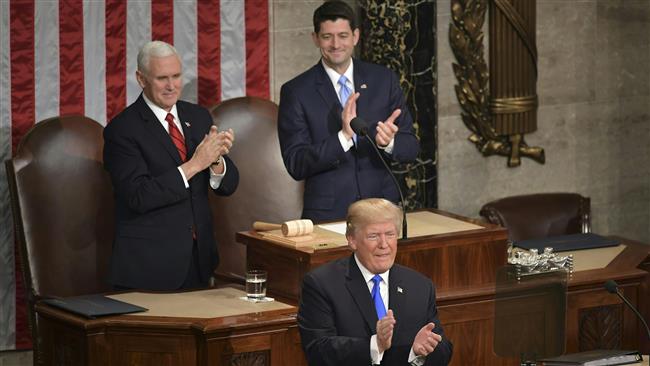 US President Donald Trump (C), backed by US Vice President Mike Pence (L) and Speaker of the House Paul Ryan claps as he arrives for his State of the Union address at the US Capitol in Washington, DC, on January 30, 2018. (Photo by AFP)
