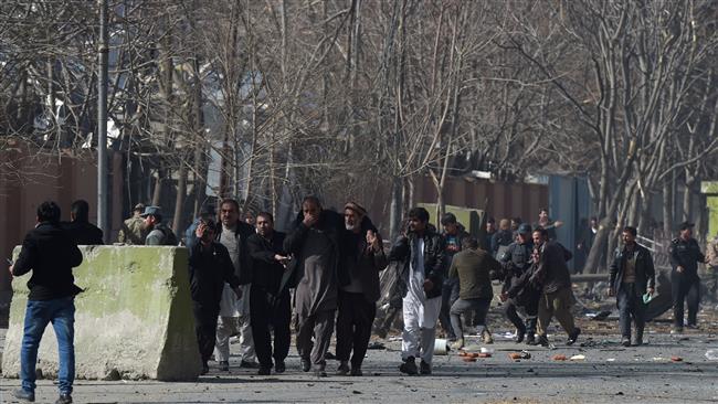 Afghan volunteers and policemen help the wounded at the scene of a Taliban car bomb attack in Kabul on January 27, 2018. (Photo by AFP)