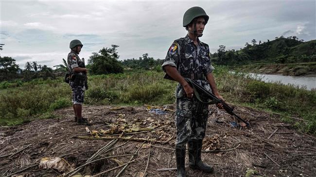 This file photo, taken on July 14, 2017, shows border police standing guard at Tinmay Village, Buthidaung Township in Myanmar’s Rakhine State. (By AFP)
