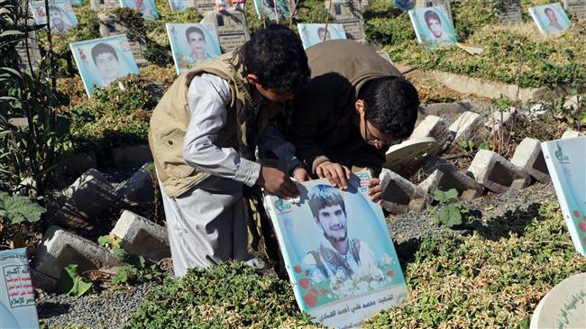 Boys look at the picture of a relative on his grave at a graveyard for fighters of the Houthi Ansarullah movement in Sa’ada, Yemen, on January 30, 2018. (Photo by Reuters)