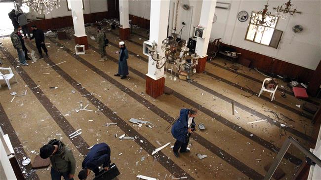 People inspect the interior of a mosque in Benghazi, Libya, on February 9, 2018, after it was hit with a twin bomb attack. (Photo by AFP)