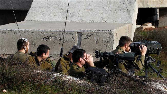 A picture taken on February 10, 2018 show Israeli soldiers taking positions in the Israeli-occupied Golan Heights near the border with Syria. (By AFP)