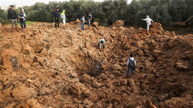 Palestinians check the site of an Israeli airstrike in Gaza City on February 18, 2018. (Photo by AFP)