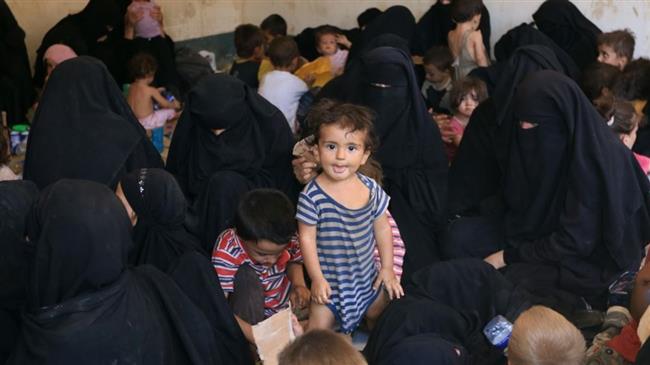 Families and relatives of Daesh Takfiri militants are seen after surrendering themselves to the Kurdish Peshmerga forces in al-Ayadiya, northwest of Tal Afar, Iraq, on August 30, 2017. (Photo by Reuters)