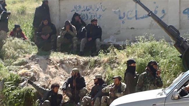 This file image posted on the Twitter page of Jabhat Fateh al-Sham terrorists on April 25, 2015, shows militants of the Takfiri group in the Syrian town of Jisr al-Shughour, in Idlib province.