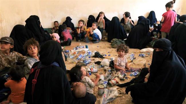 Families and relatives of Daesh militants are seen after they surrender themselves in Iraq.