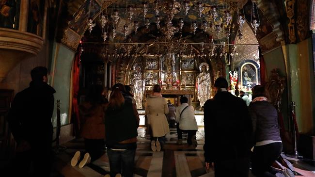 Christian worshippers pray inside the Church of the Holy Sepulchre in Jerusalem al-Quds after it reopened on February 28, 2018, following a three-day closure to protest against Israeli tax and land grab plans targeting churches in the city. (Photo by AFP)