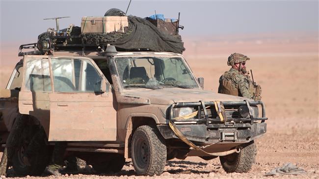 A US fighter stands near a military vehicle, north of Raqqah city, Syria, on November 6, 2016. (Photo by Reuters)