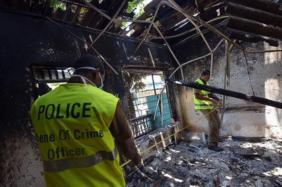 Sri Lankan police look at a burnt home in Digana, a suburb of Kandy, on Thursday. Sri Lankan police said petrol bombs were hurled at a mosque as hundreds of troops patrolled a troubled central district where anti-Muslim violence has left three people dead. (AFP)