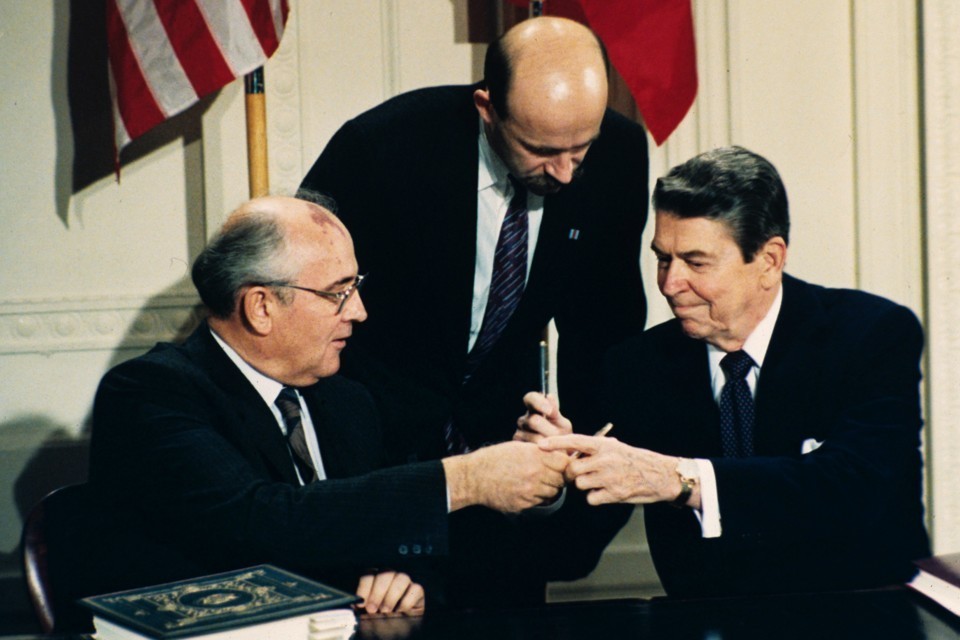Mikhail Gorbachev and Ronald Reagan exchange pens at the Intermediate Range Nuclear Forces Treaty signing ceremony. Bob Daugherty / AP