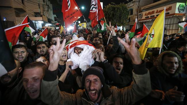 Palestinians carry the body of 24-year-old old Muhammad Zain al-Jaabari, who was shot during clashes with Israeli forces, as they walk in a procession down a street in the occupied West Bank city of al-Khalil on March 9, 2018. (Photo by AFP)