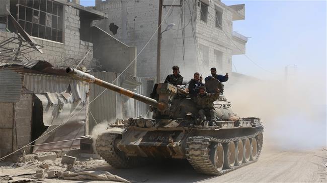 Syrian government forces deploy in the captured Beit Sawa town of the Eastern Ghouta region on the outskirts of Damascus on March 14, 2018. (Photo by AFP)