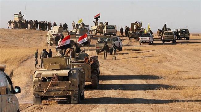 This file photo of Iraqi forces, supported by members of the Hashed al-Shaabi (Popular Mobilization Units), shows them advancing in the western desert in the northern Iraqi region of al-Hadar south of Mosul.