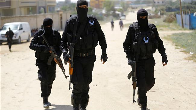 Hamas policemen carry out a raid in Nuseirat, south of Gaza City on March 22, 2018, that resulted in the arrest of a suspect in a recent bomb attack against the Palestinian prime minister. (Photo by AFP)