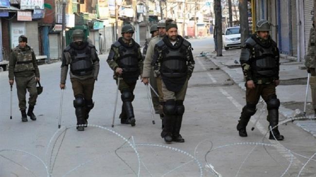 File photo shows Indian security forces patrolling on a street during curfew in Srinagar on February 10, 2013. (by AFP)