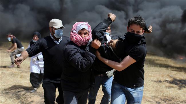 Palestinians carry a wounded demonstrator during clashes with Israeli forces following a protest east of the Jabalia refugee camp in the northern Gaza Strip on April 6, 2018. (Photo by AFP)