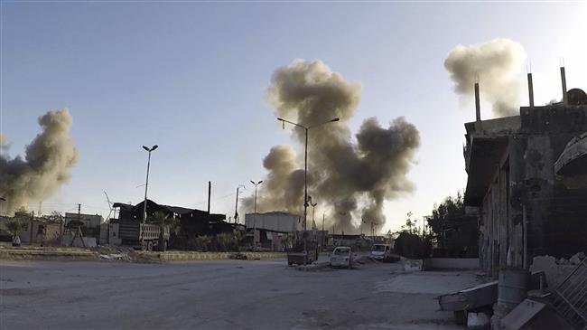 This photo shows smoke rising after airstrikes hit in the Syrian town of Douma, Eastern Ghouta, on April 7, 2018. (Photo by AP)