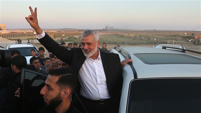 Hamas leader Ismail Haniyeh flashes the "V" for victory sign as he makes a stop on April 9, 2018 at the site of protests on the Israel-Gaza border east of Gazy City.