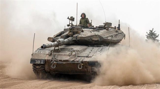 In this file picture, an Israeli Merkava tank moves towards the border between the Gaza Strip and the occupied Palestinian territories. (Photo by AFP)