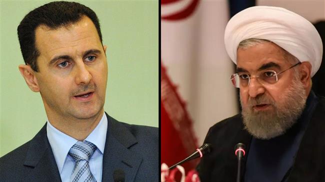 Iranian President Hassan Rouhani (R) and his Syrian counterpart Bashar al-Assad