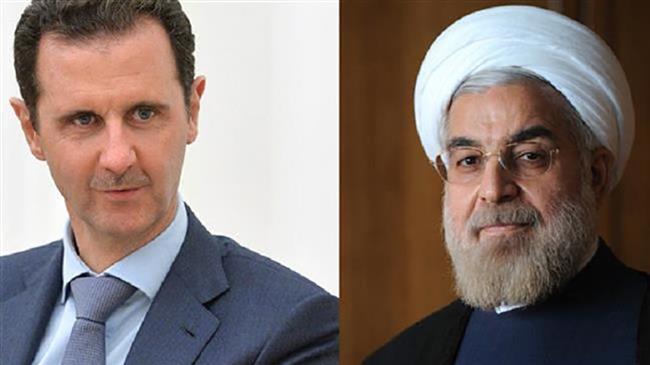 Iranian President Hassan Rouhani (R) and his Syrian counterpart Bashar al-Assad