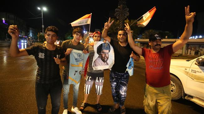 Iraqi men celebrate during the general election in Baghdad on May 14, 2018. (Photo by AFP)