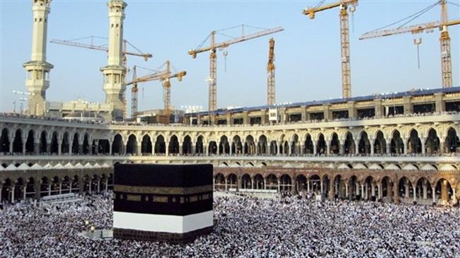 This photo shows cranes in the background at construction sites behind Mecca
