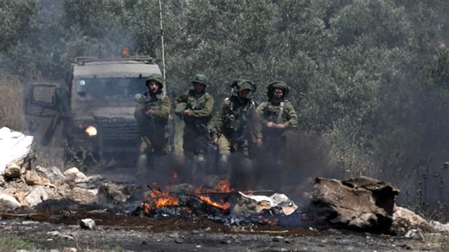 Israeli soldiers take position during a weekly demonstration against the expropriation of Palestinian land by Israel in the village of Kfar Qaddum, near Nablus in the occupied West Bank, on May 11, 2018. (Photo by AFP)