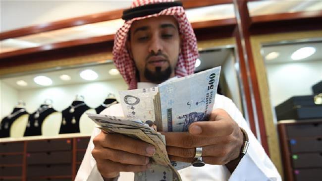 A Saudi man counts banknotes at his jewelry shop in Riyadh, Saudi Arabia. (AFP)