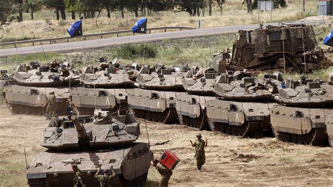 Israeli soldiers walk by Merkava Mark IV tanks during a military drill in the Israeli-annexed Golan Heights on May 1, 2018. (Photo by AFP)