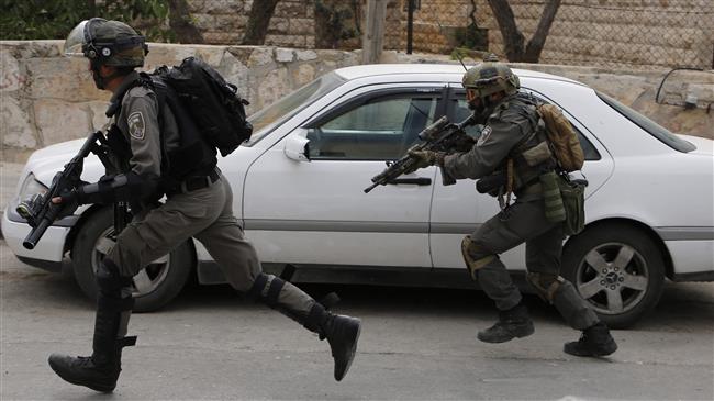 Israeli troops run during clashes with Palestinian youths in the Amari refugee camp near the city of Ramallah in the occupied West Bank after they stormed the camp on May 28, 2018. (Photo by AFP)