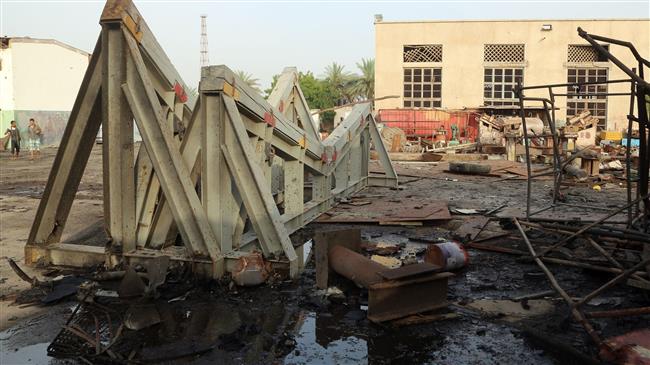 Workers inspect damages at the site of an air strike on the maintenance hub at the Hudaydah port, on May 27, 2018. (Photo by AFP)