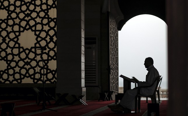 Man reads Quran in mosque before iftar.