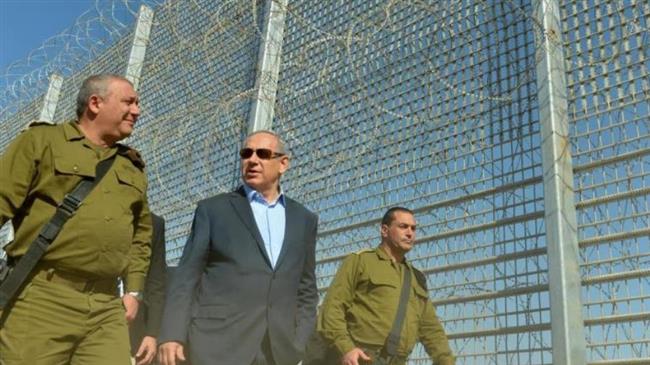 This photo taken from Israeli media shows Prime Minister Benjamin Netanyahu (C) during a tour of military posts in the southern parts of the occupied territories.