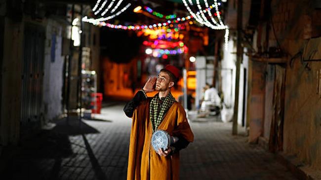 File photo of a Palestinian Musaharati, the person performing the ritual of waking fellow Muslims up for the meal they need to eat before starting to fast