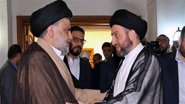 In this photo provided by the Sadr Media Office, Shia cleric Muqtada al-Sadr (L) greets Ammar al-Hakim on his arrival for a meeting in Baghdad, Iraq, May 22, 2018. (Via AP)