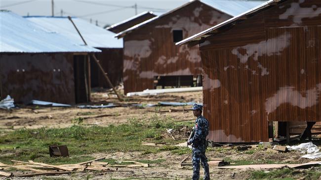 An armed Myanmarese border guard is seen at a processing camp for minority Rohingya Muslims in Maungdaw, Rakhine State, near the border with Bangladesh, on April 24, 2018. (Photo by AFP)