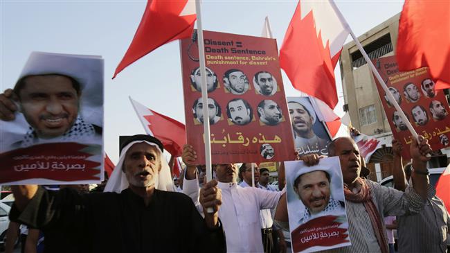 Bahraini protesters hold up images of jailed Shia opposition leader Sheikh Ali Salman and other protesters sentenced to death as they chant slogans demanding their freedom during a protest in Daih, March 3, 2015. (Photo by AP)