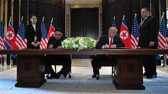 US President Donald Trump (2nd-R) and North Korea’s leader Kim Jong-un (2nd-L) sign a document as US Secretary of State Mike Pompeo (R) and the North Korean leader’s sister, Kim Yo-jong (L), look on at a signing ceremony during a historic US-North Korea summit, at the Capella Hotel on Sentosa Island in Singapore, on June 12, 2018. (Photo by AFP)