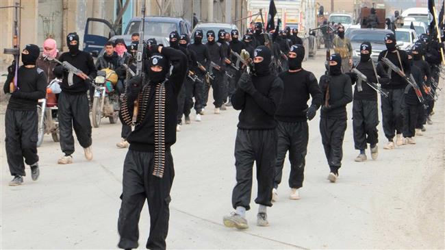 This file picture shows Daesh Takfiri terrorists parading along a street in an undisclosed location in Syria. (Photo by Reuters)
