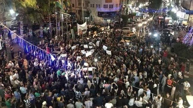 Hundreds of Palestinians stage a protest in Ramallah against sanctions imposed by the Palestinian Authority on the Gaza Strip on June 11, 2018.