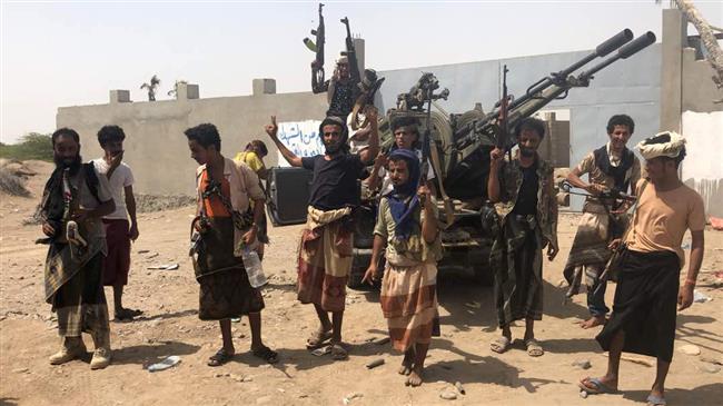 Saudi-backed Yemeni militants, loyal to ex-president Abd Rabbuh Mansur Hadi, are seen outside the city of Hudaydah on June 18, 2018. (Photo by AFP)