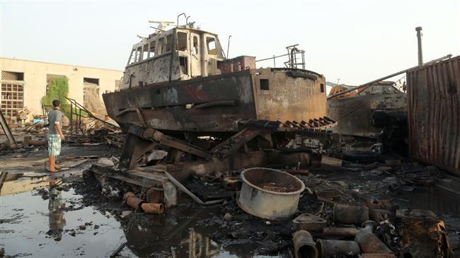 Workers inspect damages at the site of an air strike on the maintenance hub at the Hudaydah port, on May 27, 2018. (Photo by AFP)