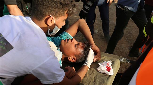 Palestinian protesters carry a protester injured by Israeli forces during a demonstration along the border between the Gaza Strip and the Israeli-occupied territories, east of Khan Younis in the southern Gaza Strip, on June 22, 2018. (Photo by AFP)