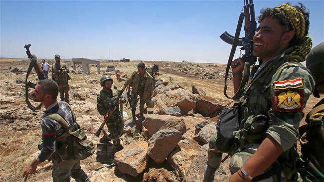 Syrian soldiers hold their weapons during a government-guided tour in the village of al-Sourah, in the province of Dara’a, on June 29, 2018. (Photo by AFP)