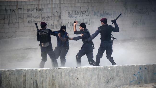 In this file picture, Bahraini regime forces arrest a protester during demonstration against the ruling Al Khalifah regime in the village of Shakhura, west of Manama. (Photo by AFP)