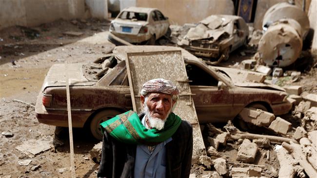 A man stands next to cars damaged by a Saudi airstrike in Amran, Yemen, on June 25, 2018. (Photo by Reuters)